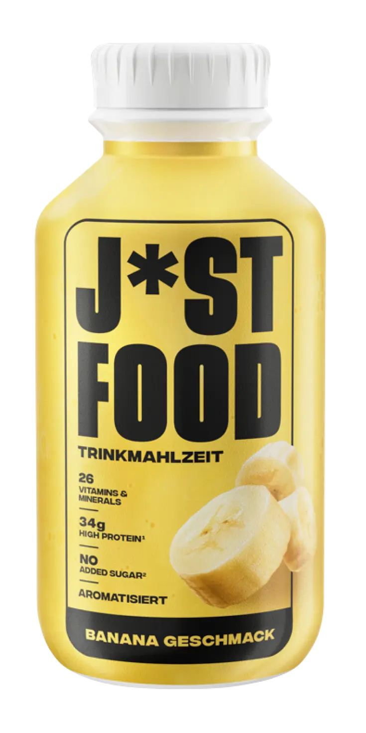 Eine gelbe Flasche mit weißem Deckel zeigt die Aufschrift "J*ST FOOD TRINKMAHLZEIT" und "BANANA GESCHMACK", begleitet von Angaben zu Vitaminen, Protein und Zucker, sowie einem Bananenbild.
